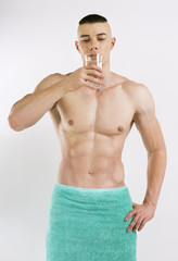 athletic young man with glass of fresh water