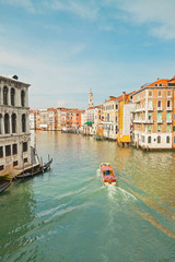 Colorful canal of Venice with houses and boat. View from Rialto