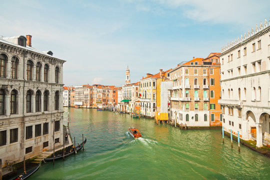 Colorful canal of Venice with houses and boat. View from Rialto