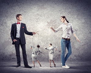 Businesspeople with marionettes