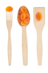 Wooden spoon, fork, paddle with dried apricots