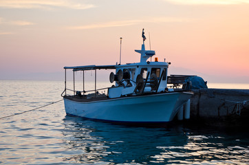 Fishing boat at the dock in sunset