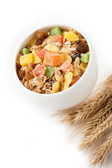 Granola (muesli flakes)  in a bowl and ears of wheat