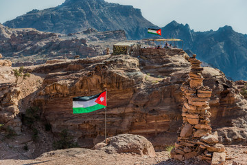 jordan flags floating in nabatean city of  petra
