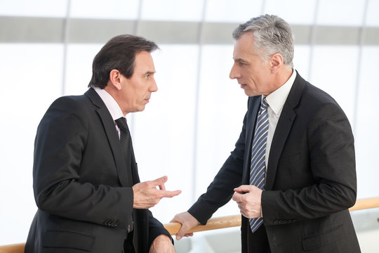 Mature executive discussing with associate