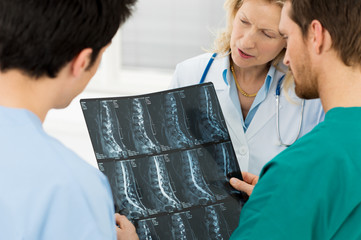 Doctors Examining X-ray Report