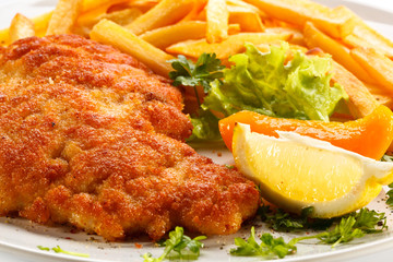 Pork chop, French fries and vegetables