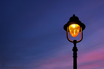 lamppost illuminated at twilight