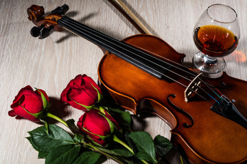 Fototapeta premium Violin, rose, glass of champagne and music books