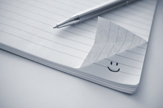 Notepad with a smiley icon