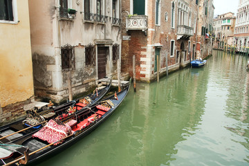 Fototapeta na wymiar Canal and gondolas in Venice, Italy