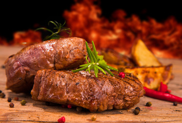 Grilled steaks on wood