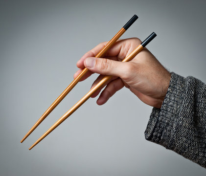 Male hand with chopsticks