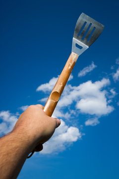 Hand Holding BBQ Spatula