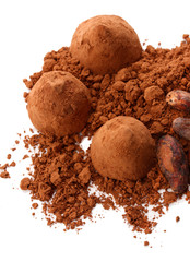 Chocolate truffles and cocoa isolated on white