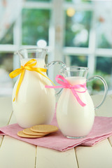 Pitchers of milk on table in room