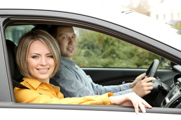 Portrait of young beautiful  couple sitting in the car