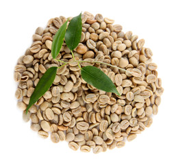 Green coffee beans and leaves isolated on white