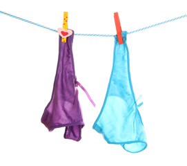 Women's panties hanging on rope isolated on white