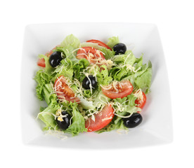 Light salad on plate isolated on white