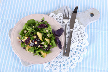 Light salad on plate on napkin