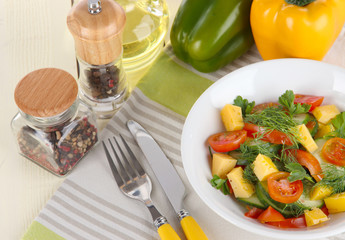 Light salad in plate on wooden table