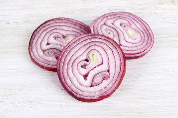 Purple onion on cutting board isolated on white