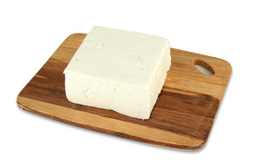 Sheep milk cheese on cutting board, isolated on white