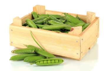 Sweet green peas in wooden box isolated on white