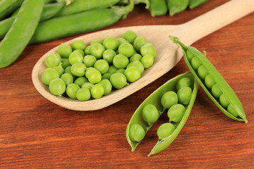 Sweet green peas on wooden background