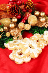 Christmas cookies and decorations on color fabric background