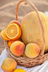 basket with fruit on beach 