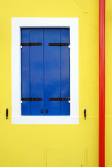 Blue window on yellow wall