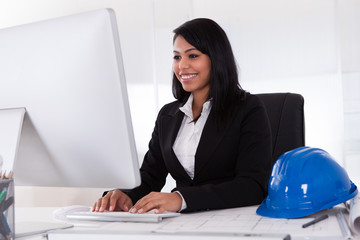 Happy Female Architect Using Computer