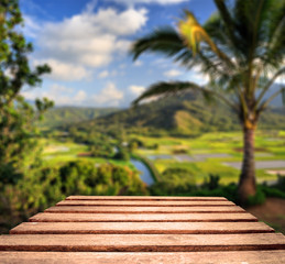 Fototapeta premium Worn Table Top with tropical background
