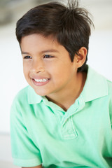 Obraz premium Smiling Boy Sitting On Sofa