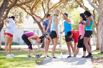 Group Of Runners Warming Up Before Run