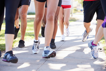 Fototapeta na wymiar Close Up Of Runners Feet On Suburban Street