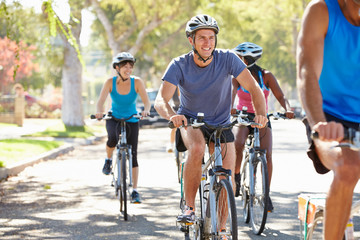 Group Of Cyclists On Suburban Street
