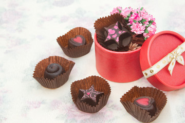 Chocolate Truffles with bouquet of pink roses in the red box