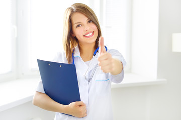 Female doctor showing thumbs up