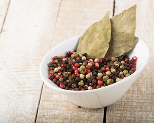 Mixed pepper white bowl on wooden background