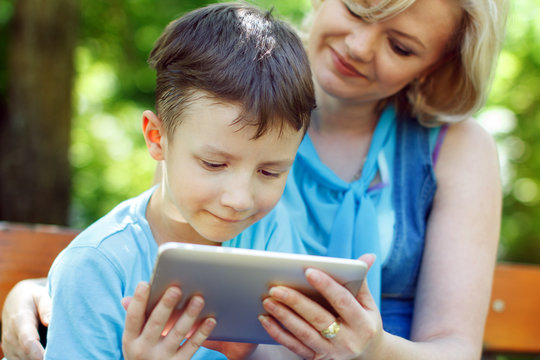 Little Boy With Tablet And Mother