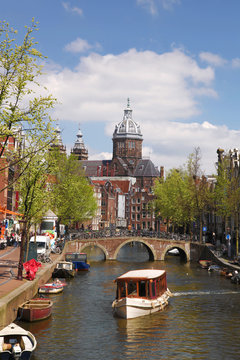 City of Amsterdam with boat on canal in Holland