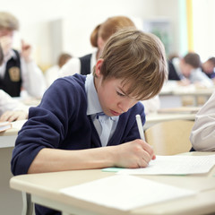 Naklejka na ściany i meble school boy struggling to finish test in class.