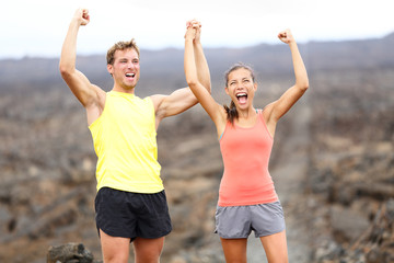 Cheering celebrating happy fitness runner couple