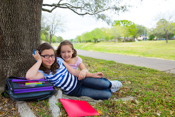 sister firends girls relaxed under tree park after school