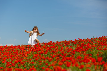 little girl in a poppy field