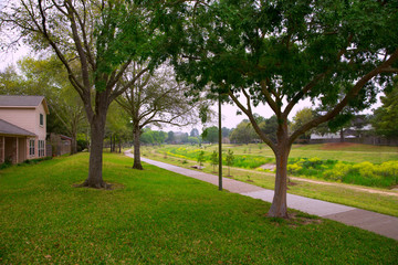 Creek park with track and green lawn grass