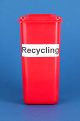 Recycling bin on blue background